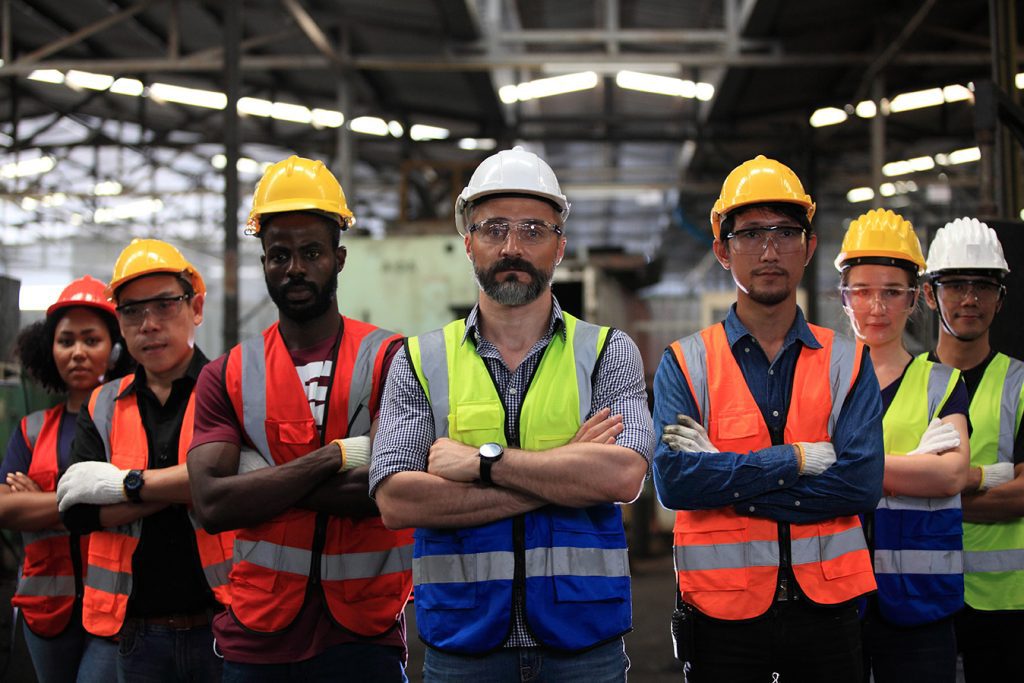 Workers wearing different colors of hi vis vests